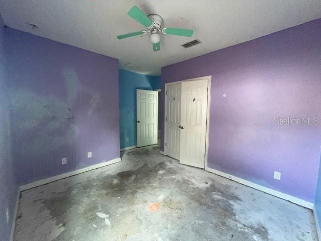 unfurnished bedroom with ceiling fan and concrete floors