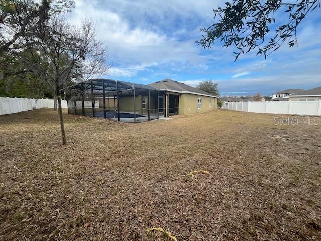 view of yard featuring glass enclosure