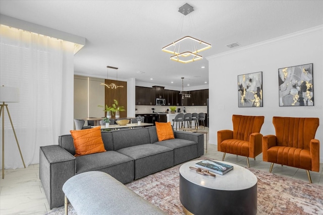 living room with crown molding and an inviting chandelier