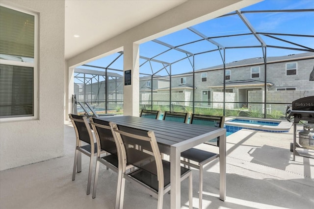 view of patio / terrace with an in ground hot tub and glass enclosure