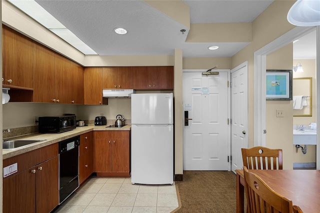 kitchen with light tile patterned floors, sink, and black appliances