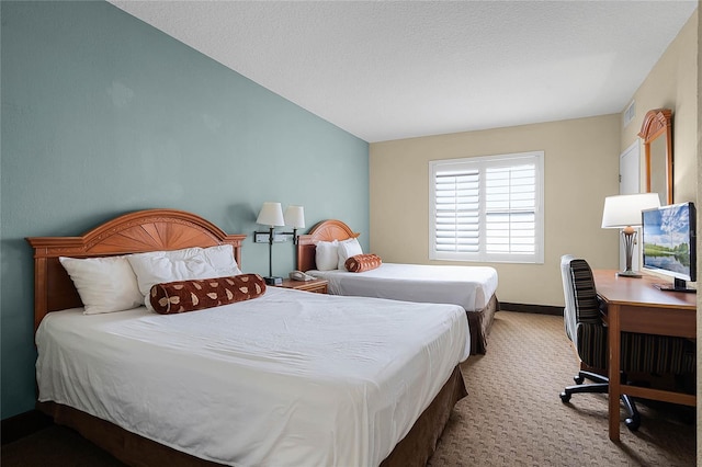 carpeted bedroom featuring a textured ceiling