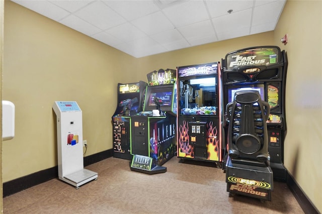 game room with carpet floors and a drop ceiling