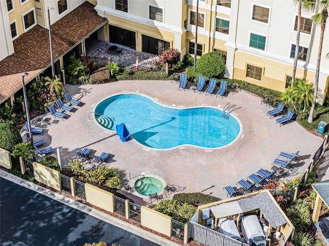 view of pool featuring a patio area and a community hot tub