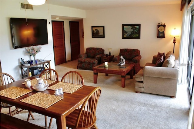 dining space featuring light colored carpet