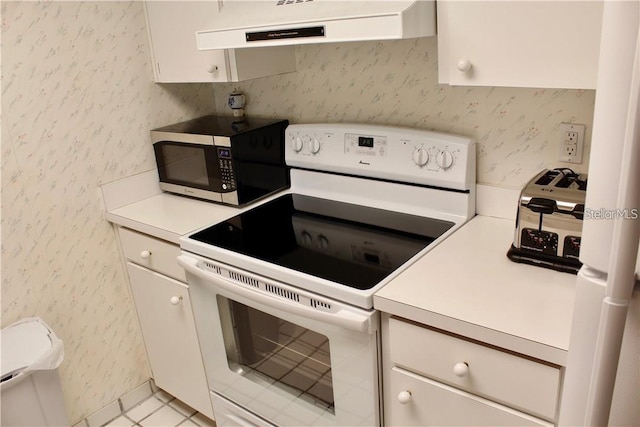 kitchen featuring white range with electric stovetop, light tile patterned floors, and extractor fan