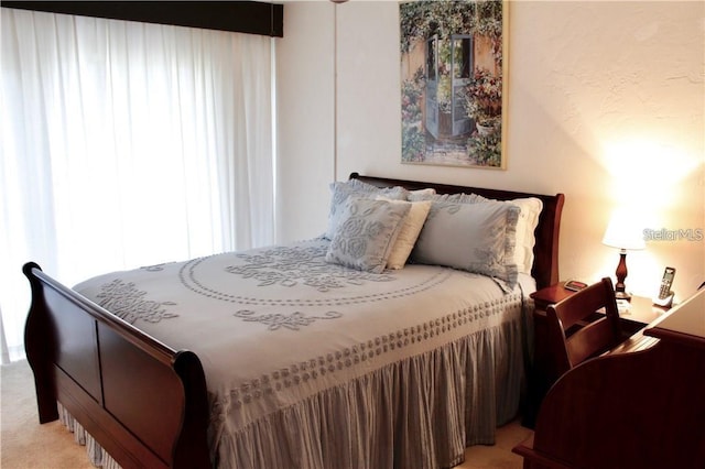 bedroom featuring light colored carpet