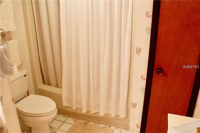 bathroom with toilet, tile patterned flooring, and shower / bath combination with curtain