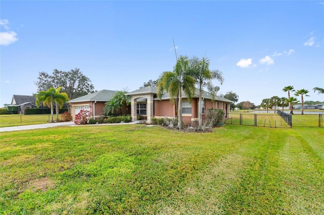 view of front of property with a garage and a front lawn