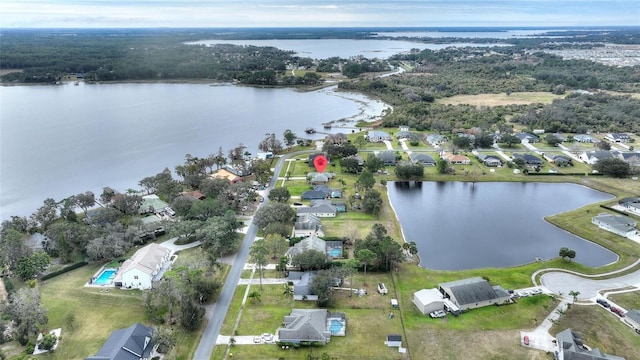 birds eye view of property with a water view