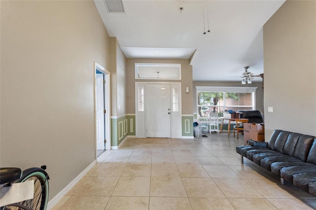 entryway featuring ceiling fan and light tile patterned floors