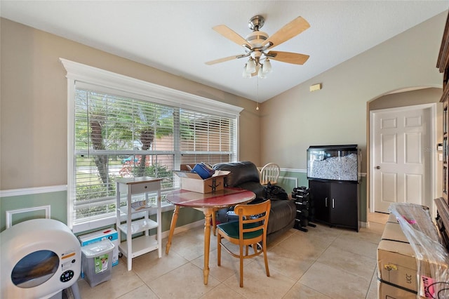 tiled office space with ceiling fan, lofted ceiling, and plenty of natural light