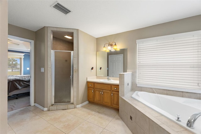 bathroom with vanity, tile patterned flooring, independent shower and bath, and a chandelier