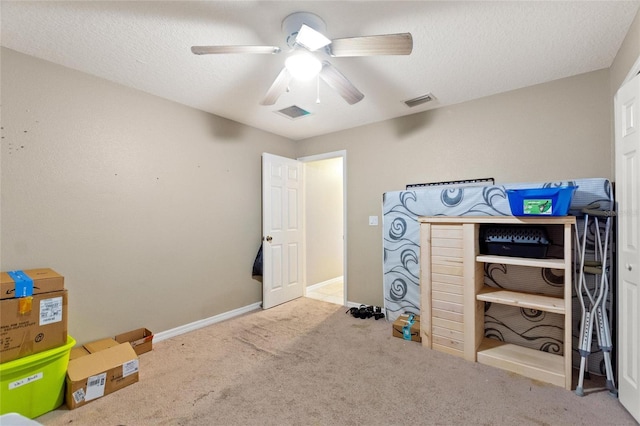 interior space featuring ceiling fan and a textured ceiling