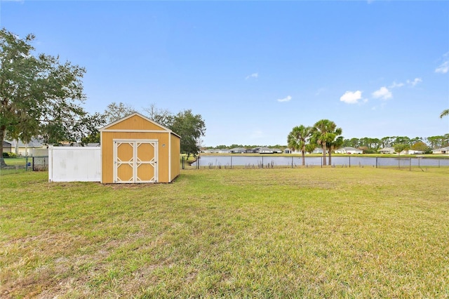 view of yard featuring a shed and a water view