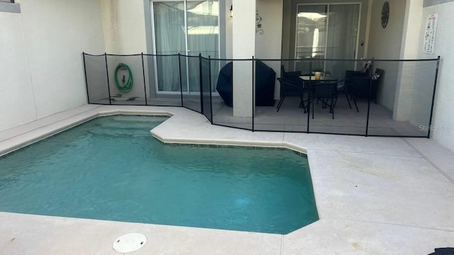 view of swimming pool featuring a patio area