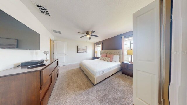 bedroom with ceiling fan and light colored carpet