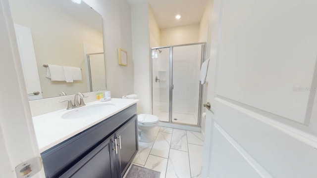 bathroom featuring a shower with shower door, toilet, and vanity