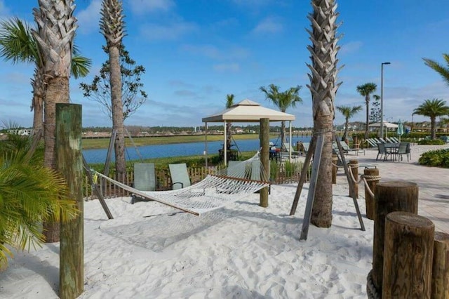 view of property's community with a gazebo and a water view