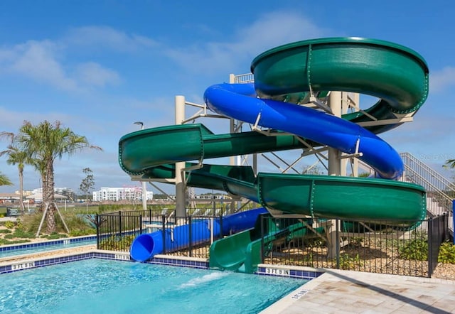 view of swimming pool with a water slide