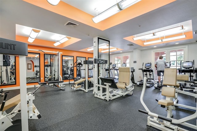 gym with a raised ceiling