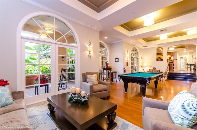 game room featuring billiards, a raised ceiling, wood-type flooring, crown molding, and french doors