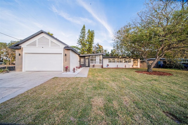 ranch-style house with a garage and a front lawn