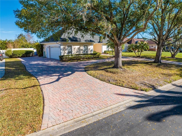 view of front facade with a garage and a front lawn