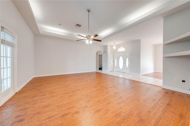 unfurnished living room featuring ceiling fan and light hardwood / wood-style floors