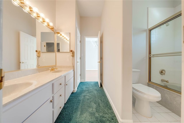 full bathroom featuring toilet, combined bath / shower with glass door, and vanity