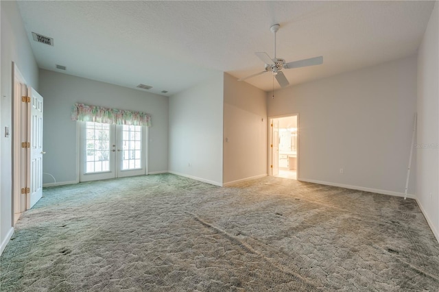 empty room featuring ceiling fan, carpet, a textured ceiling, and french doors