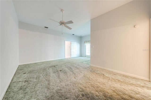 empty room with ceiling fan and light colored carpet