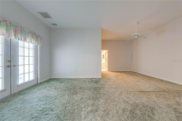 empty room featuring ceiling fan, french doors, and carpet flooring