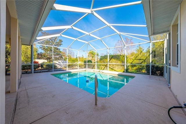 view of swimming pool featuring a patio area and glass enclosure