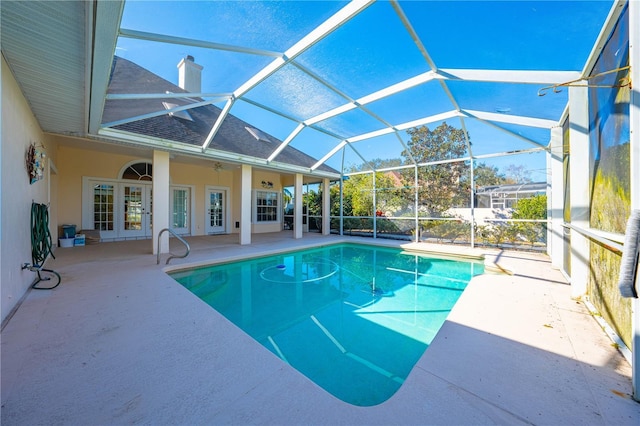 view of pool featuring ceiling fan, french doors, a patio, and glass enclosure