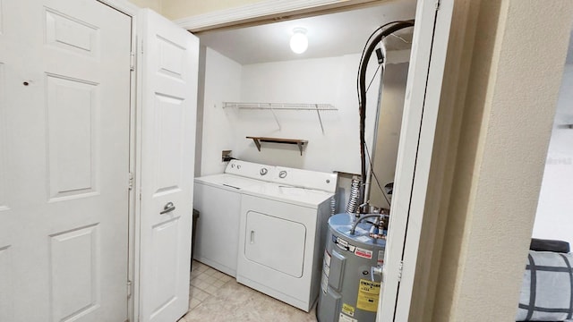 clothes washing area featuring water heater and washing machine and dryer