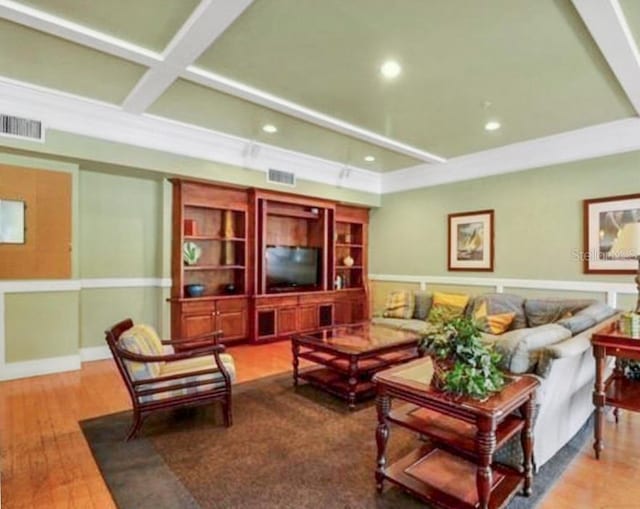 living room featuring hardwood / wood-style flooring, coffered ceiling, and beamed ceiling