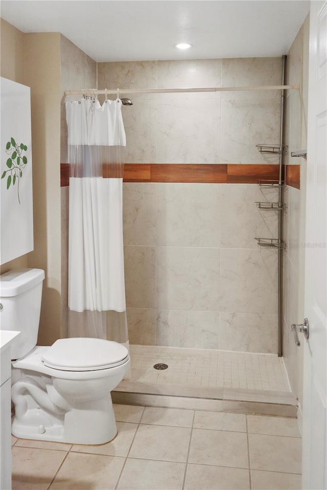 bathroom featuring toilet, tile patterned flooring, and a shower with shower curtain