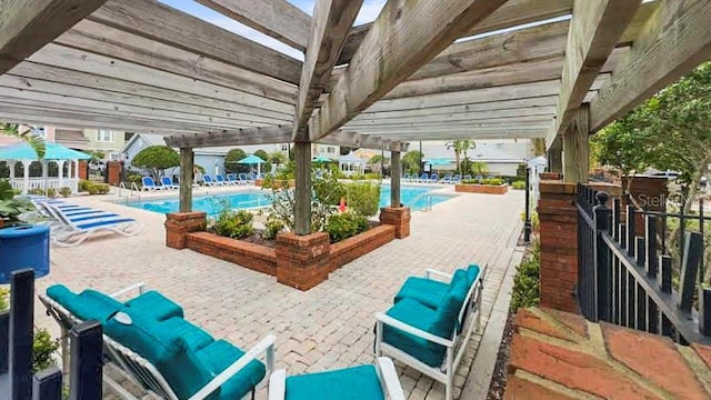 view of patio / terrace featuring a pergola and a community pool