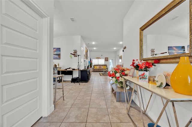 corridor featuring recessed lighting, visible vents, and light tile patterned floors