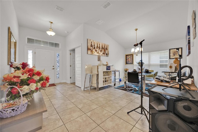 entrance foyer featuring light tile patterned floors, lofted ceiling, visible vents, and a notable chandelier