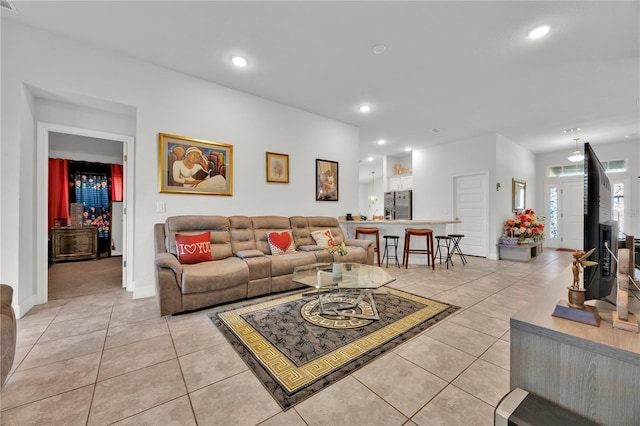 living room with light tile patterned floors, baseboards, and recessed lighting