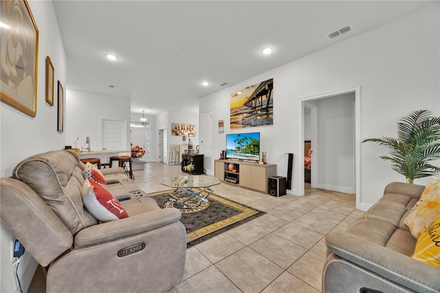 living area featuring light tile patterned floors, baseboards, visible vents, and recessed lighting