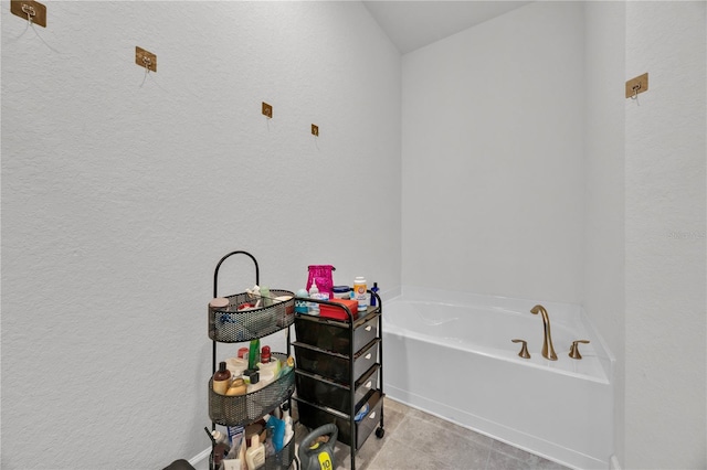 full bathroom with a bath and a textured wall