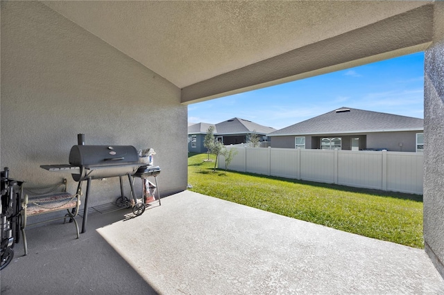 view of patio with grilling area and fence