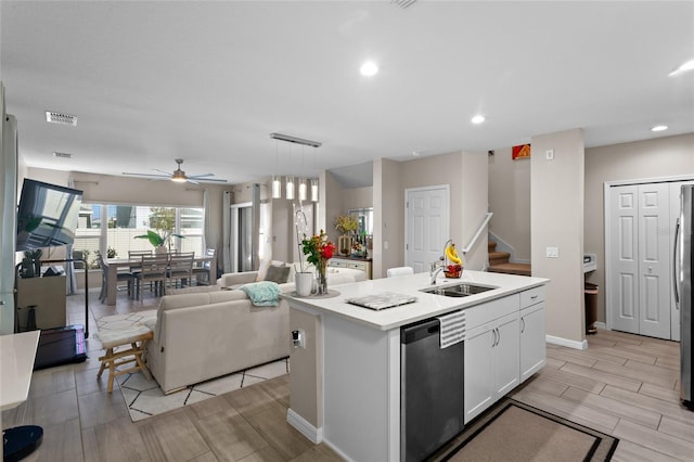 kitchen featuring white cabinetry, appliances with stainless steel finishes, sink, and a center island with sink