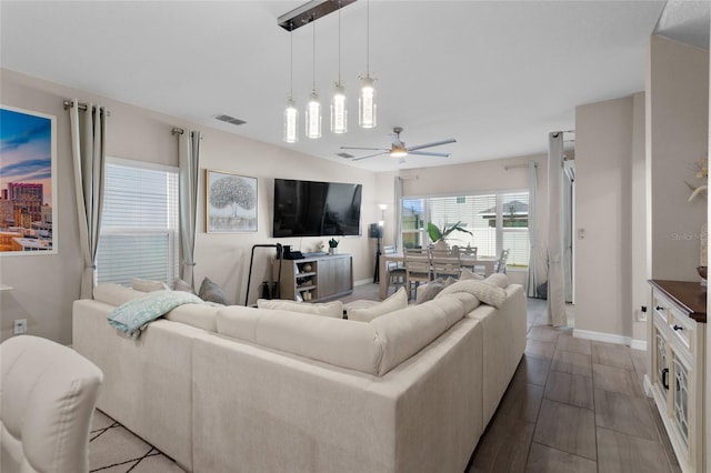 living room featuring wood-type flooring and ceiling fan