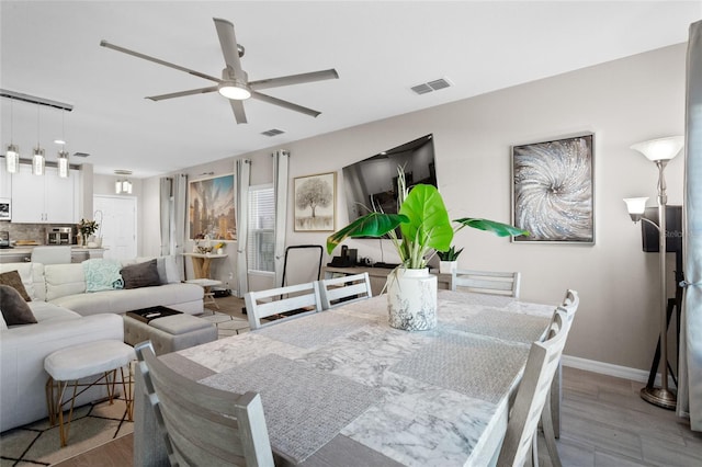 dining room featuring ceiling fan and light wood-type flooring