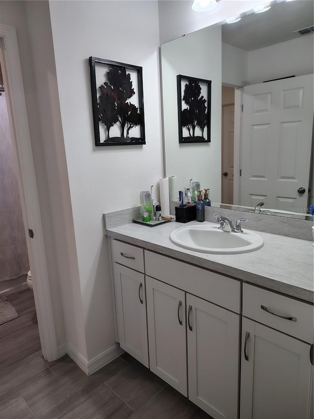 bathroom with vanity and toilet