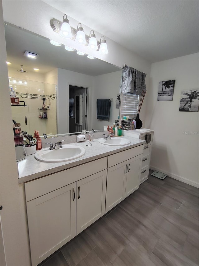 bathroom featuring vanity, wood-type flooring, and a shower with shower door